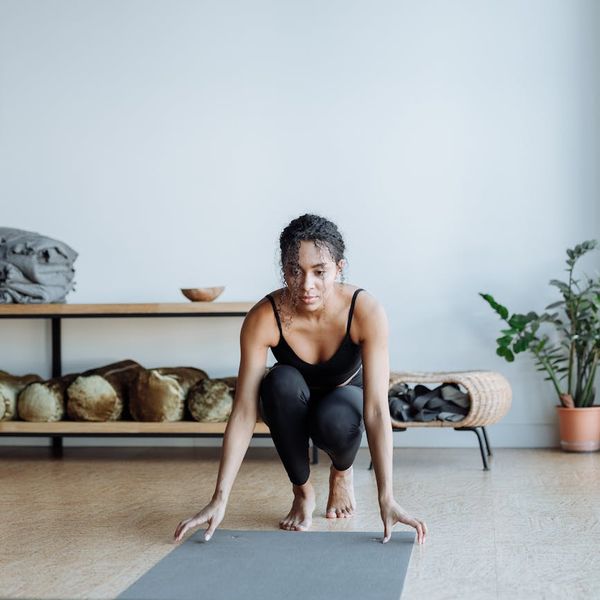A person in a warrior yoga pose against a beautiful sunrise, symbolizing energy and strength.